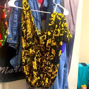 This is a nice black and gold jumpsuit it has a strap around the belly one shoul